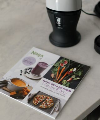 Ninja fit blender recipe book with appliance in background