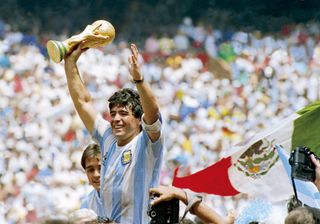 Diego Maradona celebrates with the World Cup trophy in 1986 after Argentina's win over West Germany.