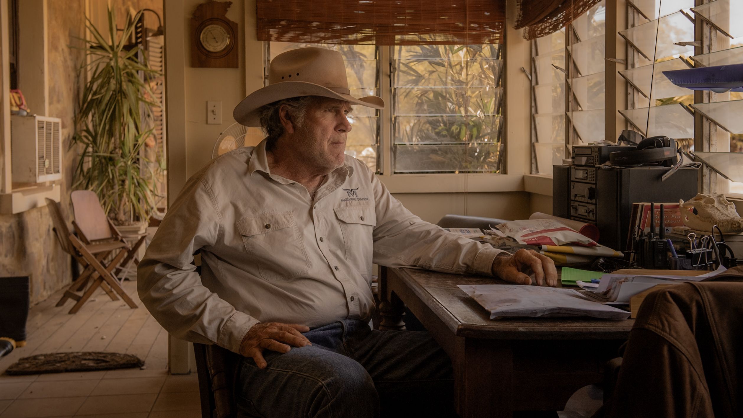 Colin Lawson (Robert Taylor) sits at Netflix and looks out the window of his office "Area"