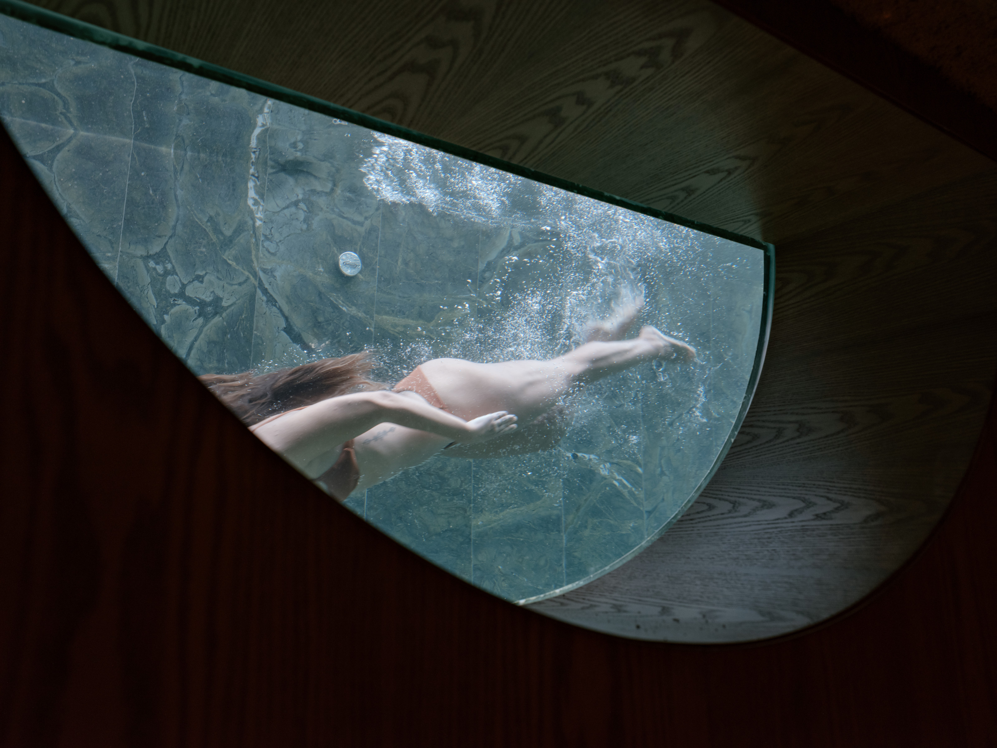 Basement windows look onto the pool