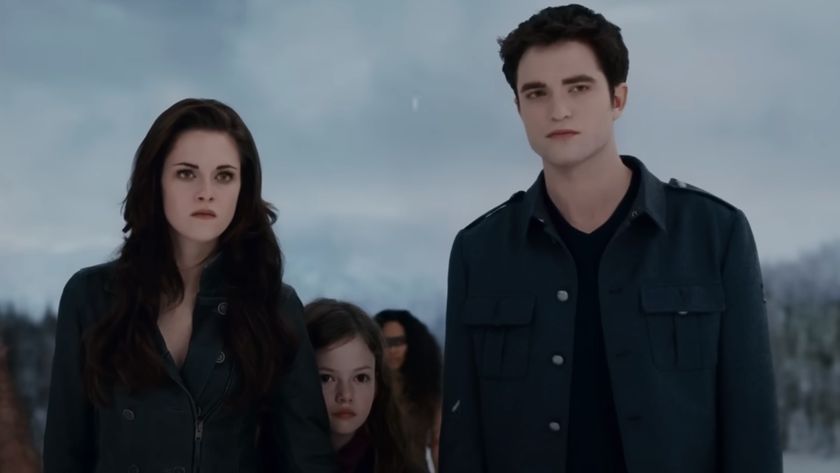Bella Cullen (Kristen Stewart) and Edward Cullen (Robert Pattinson) look on with their daughter in The Twilight Saga: Breaking Dawn - Part 2.