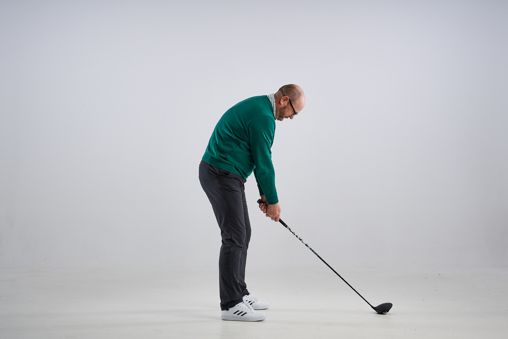 Top 50 Coach Russell Covey demonstrating an incorrect posture for the golf swing with shoulders slumped and chin tucked