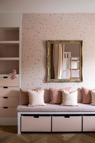 A reading nook painted in muted pink colors