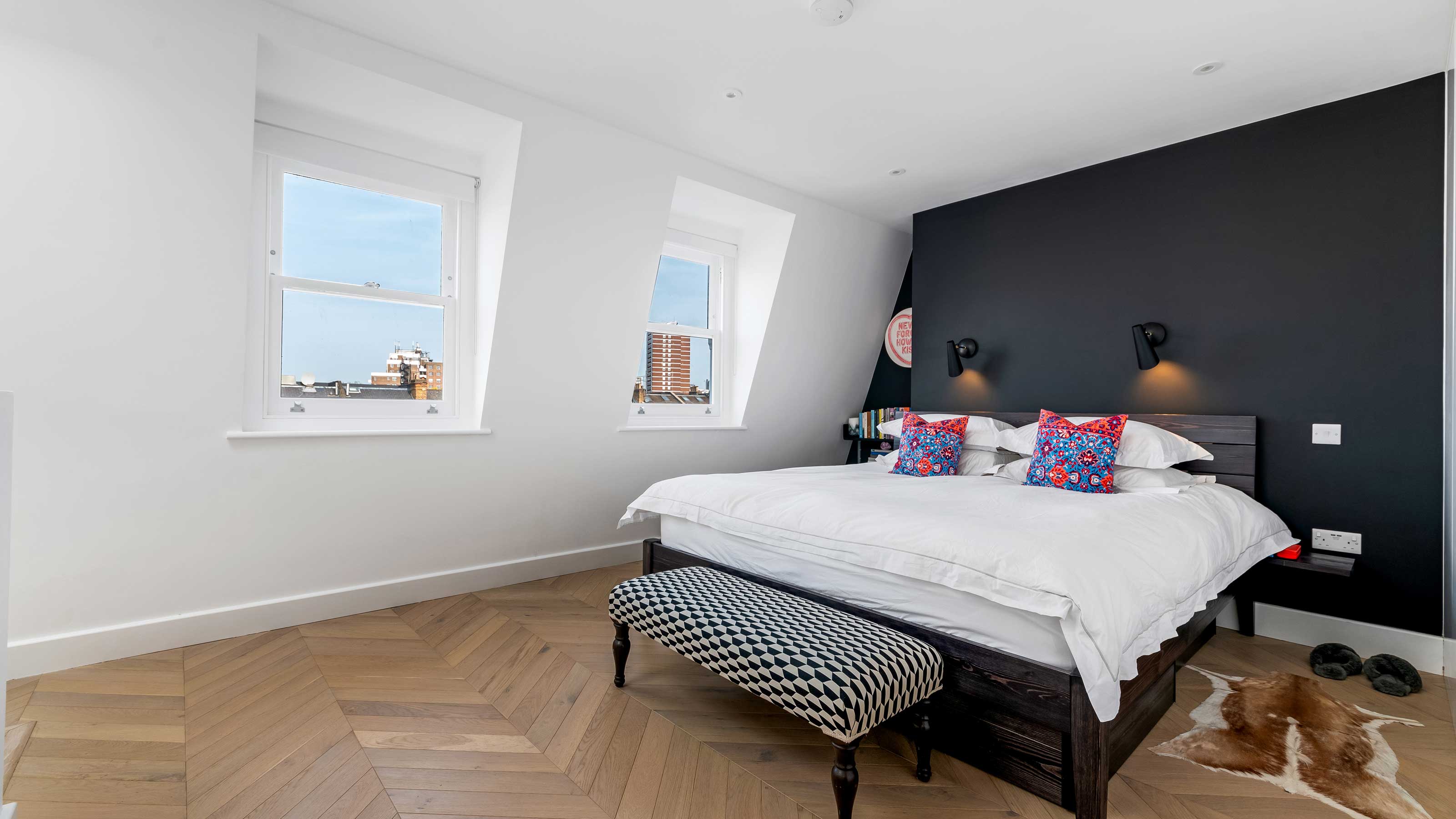 modern loft conversion bedroom with wooden herringbone flooring