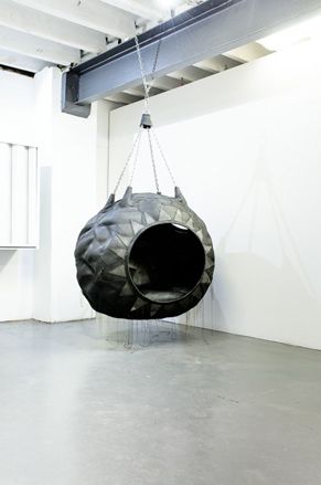 Black tire hanging from the ceiling