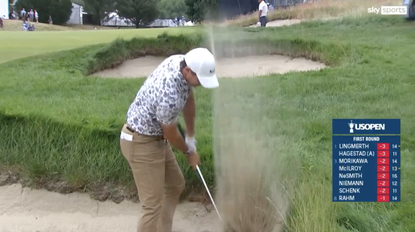 Rory McIlroy smashes a bunker with his wedge