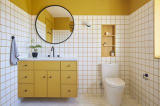 modern bathroom with yellow cabintry