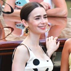 Lily Collins films Emily in Paris wearing a white and black polka dot dress
