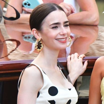 Lily Collins films Emily in Paris wearing a white and black polka dot dress