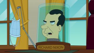 Richard Nixon's head holds up a face mask with his robot hand in Futurama.