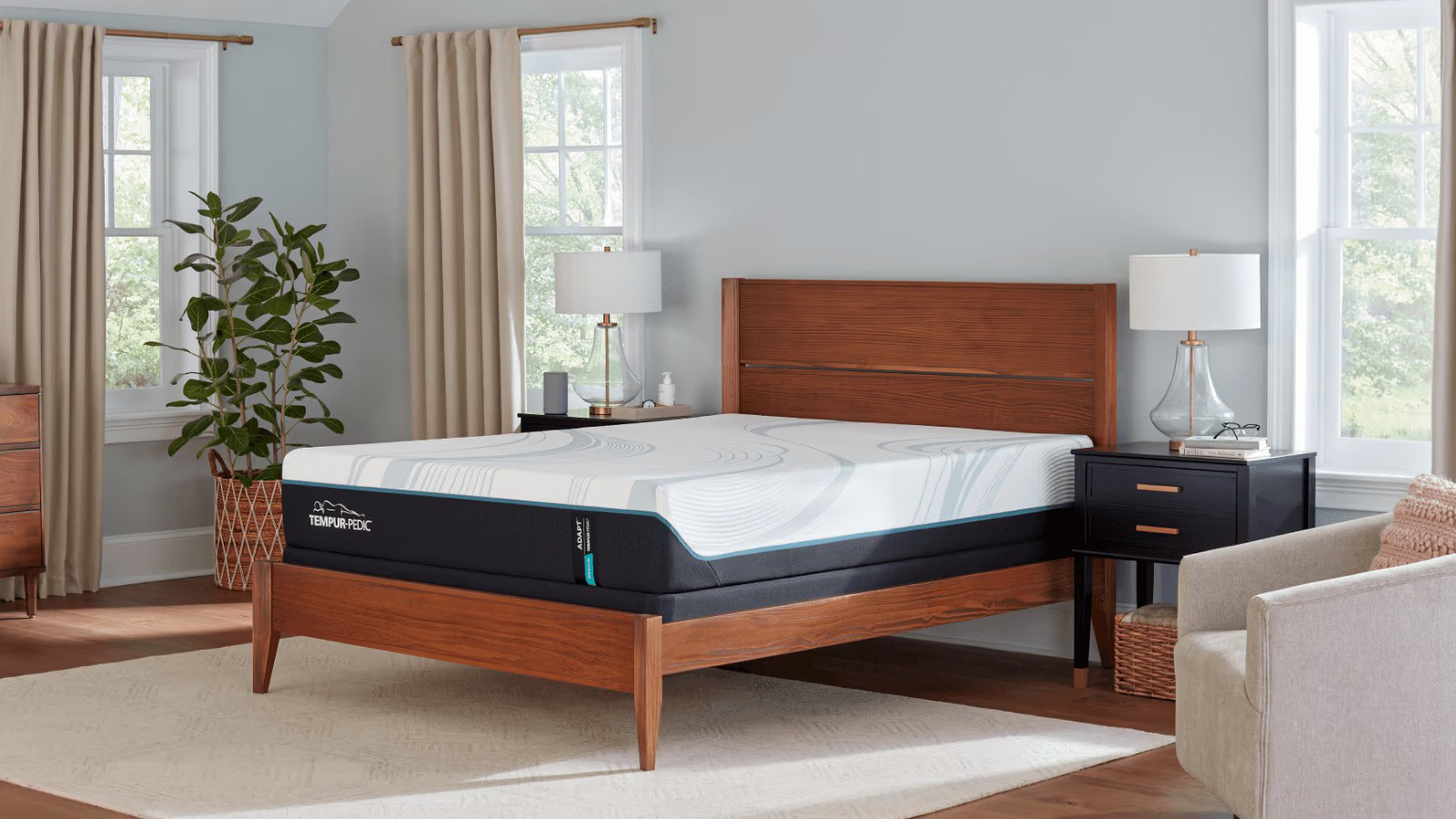 The Tempur-Pedic Tempur-Adapt Mattress, shown here on a dark wooden bed frame in a white-grey bedroom, has some of the best pressure relief we've tested for back sleepers