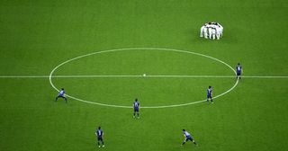 The Senegal players form a team huddle while Japan players look on before the second half during the 2018 FIFA World Cup Russia group H match between Japan and Senegal at Ekaterinburg Arena on June 24, 2018 in Yekaterinburg, Russia.