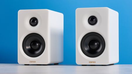 the edifier m60 bookshelf speakers in white photographed against the blue tom's guide background 