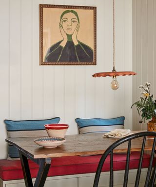 red and blue panelled small banquette seating area by laura stephens