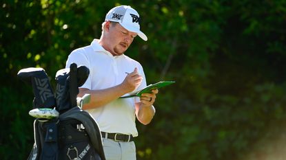 Shad Tuten goes through his scores on the eleventh hole during the third round of the Utah Championship on the Korn Ferry Tour