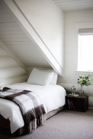 Attic farmhouse bedroom with white wash walls