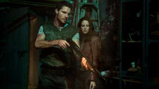 Robbie Amell examines a shotgun in front of Kaya Scodelario in Resident Evil Welcome To Raccoon City.