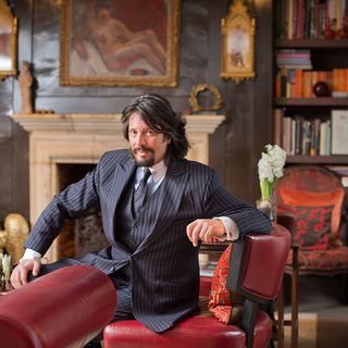 laurence llewelyn bowen sitting on house red chair