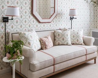 Neutral couch with throw pillows and mirror on wall