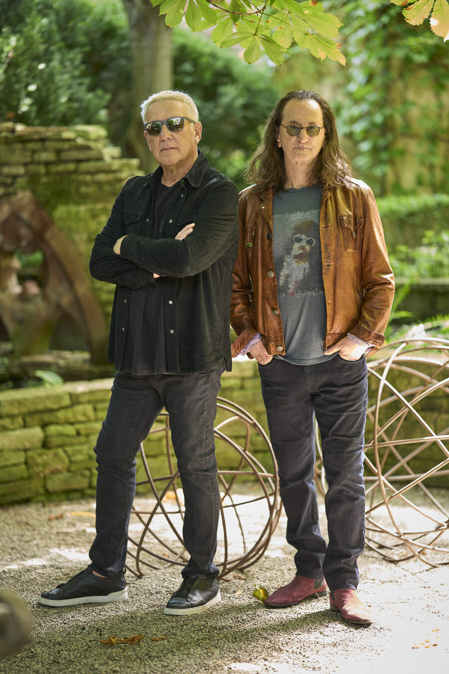 Alex Lifeson and Geddy Lee in a garden