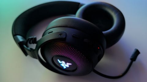 Razer Kraken V4 Pro gaming headset on a desk and with RGB enabled.