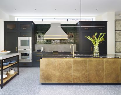Pictures of kitchens showing a dark green and black scheme with gold leaf kitchen island.