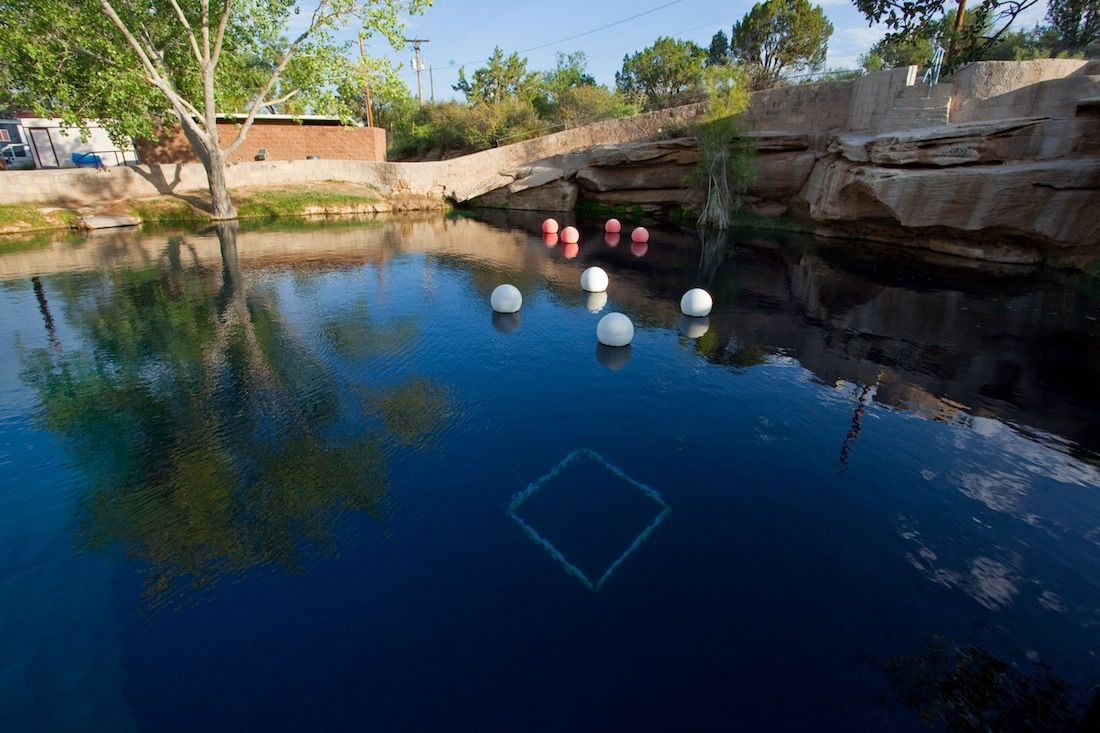 The surface of the &quot;Blue Hole&quot; in Santa Rosa, N.M. The balloons hold up underwater scuba stations used to train divers.