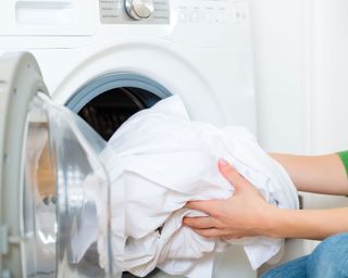 woman taking whites out of a washing machine
