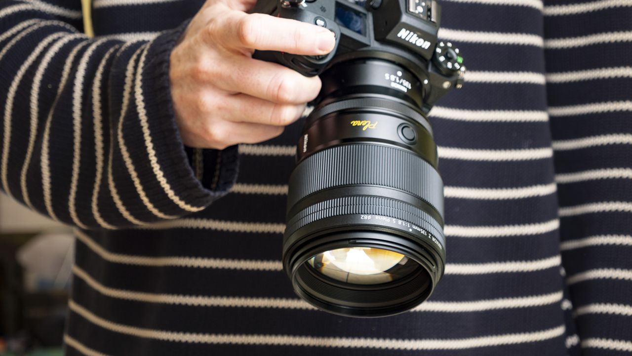 Nikon Z 135mm f/1.8 S Plena lens in the hand