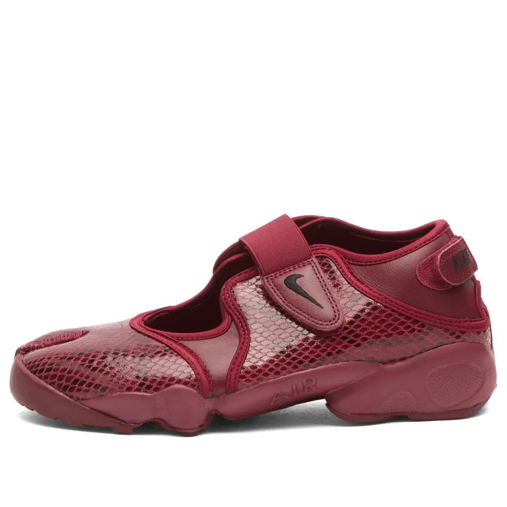 A pair of red Nike Air Rifts