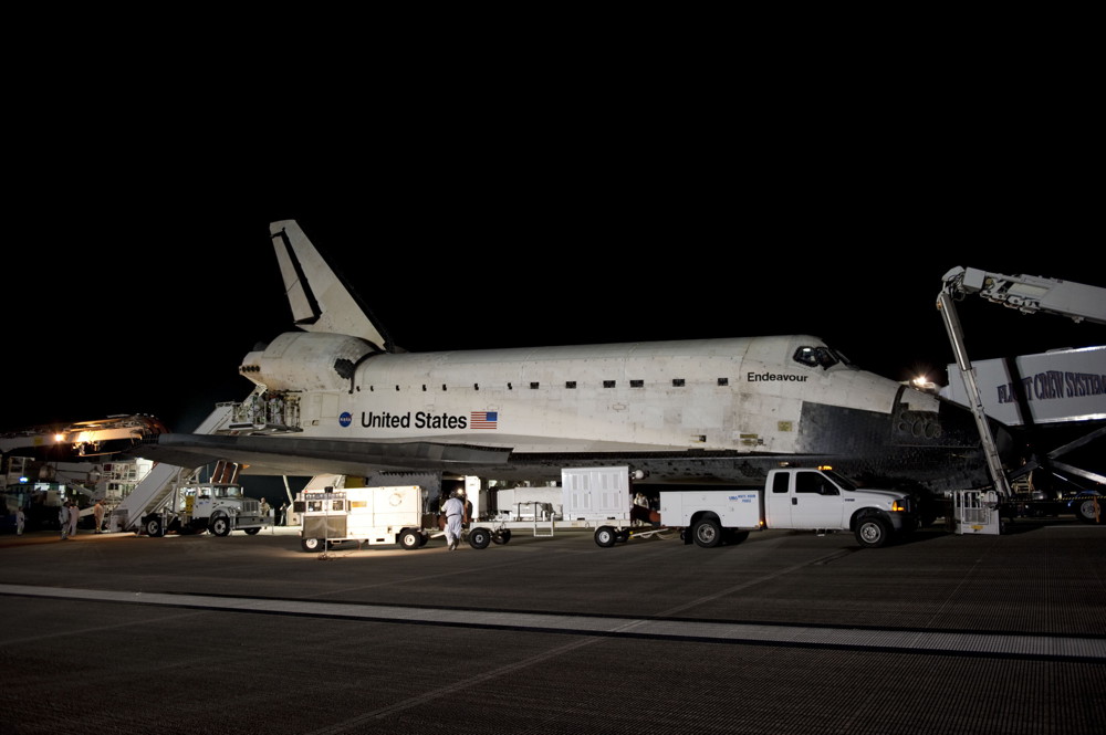 The landing convoy that will secure space shuttle Endeavour for towing to its processing hangar encircles the vehicle landing on the Shuttle Landing Facility&#039;s Runway 15 at NASA&#039;s Kennedy Space Center in Florida, on June 1, 2011.