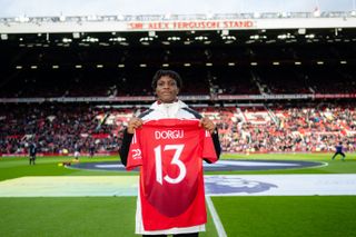 Patrick Dorgu poses with a Manchester United shirt ahead of the Premier League game against Crystal Palace after signing from Lecce.