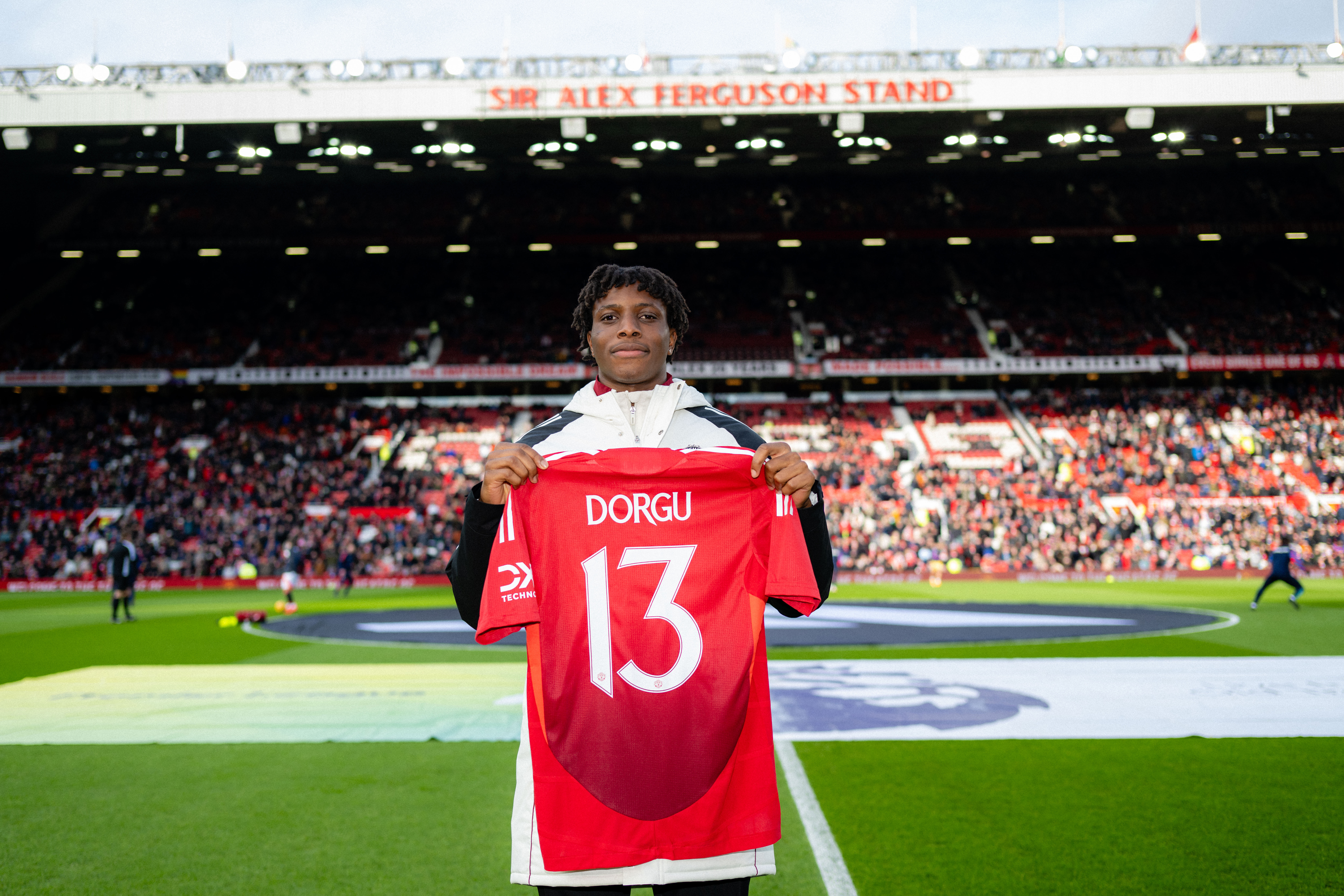 Patrick Dorgu poses with a Manchester United shirt ahead of the Premier League game against Crystal Palace after signing from Lecce.