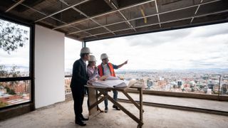 Contractor, architect and engineer working as a team at a construction site