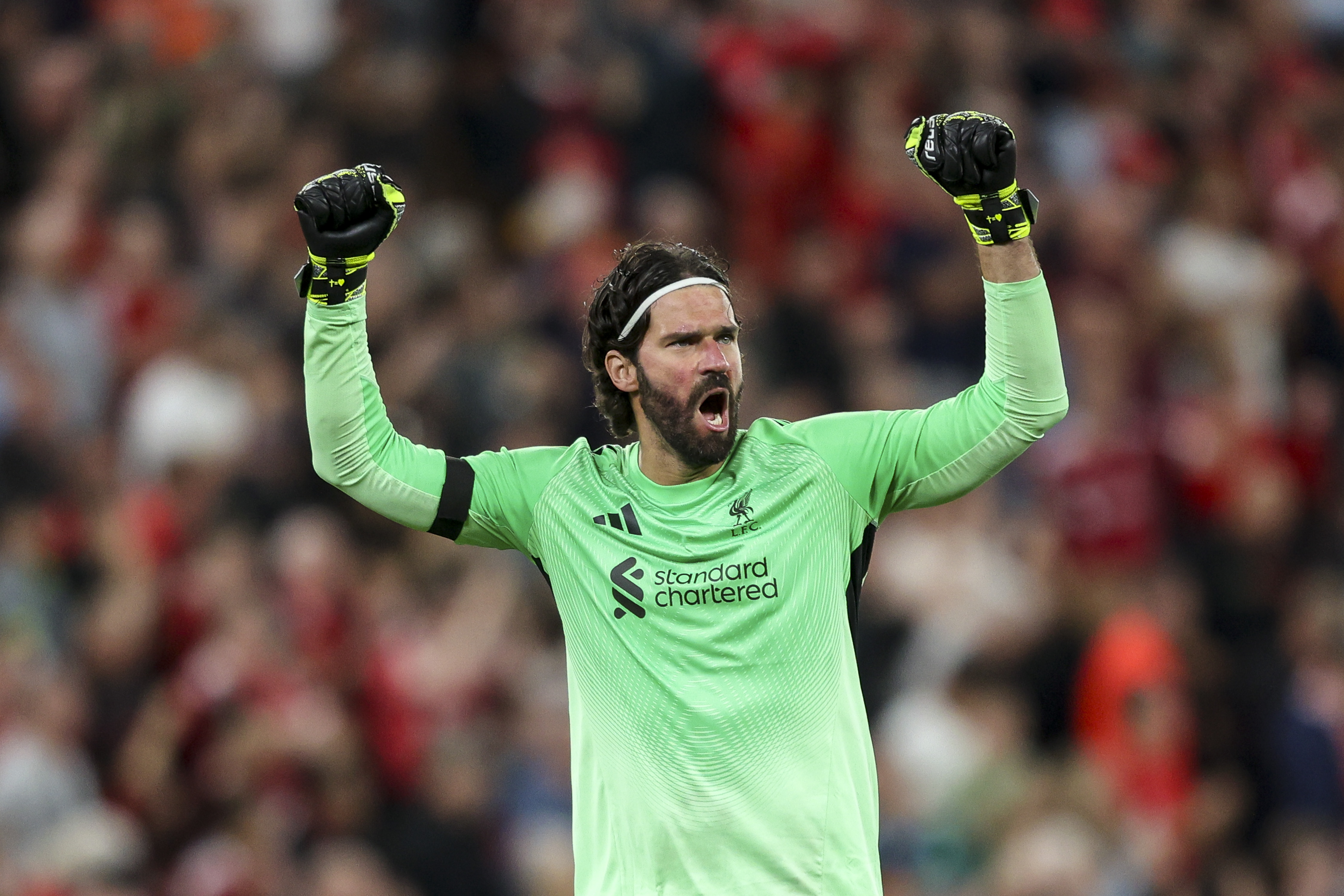 Alisson Becker celebrates at Anfield
