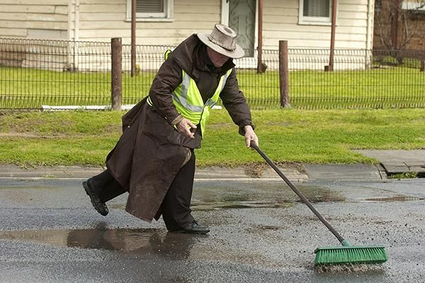 Keeping the roads clean: Tour Technical Director, Neville Williams, sweeps the roads during stage three in Grovedale.