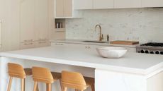 a white kitchen with a quartz countertop