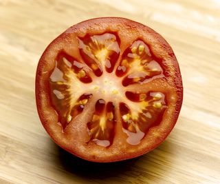 A sliced tomato on a board