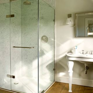 bathroom with wooden flooring and glass shower room