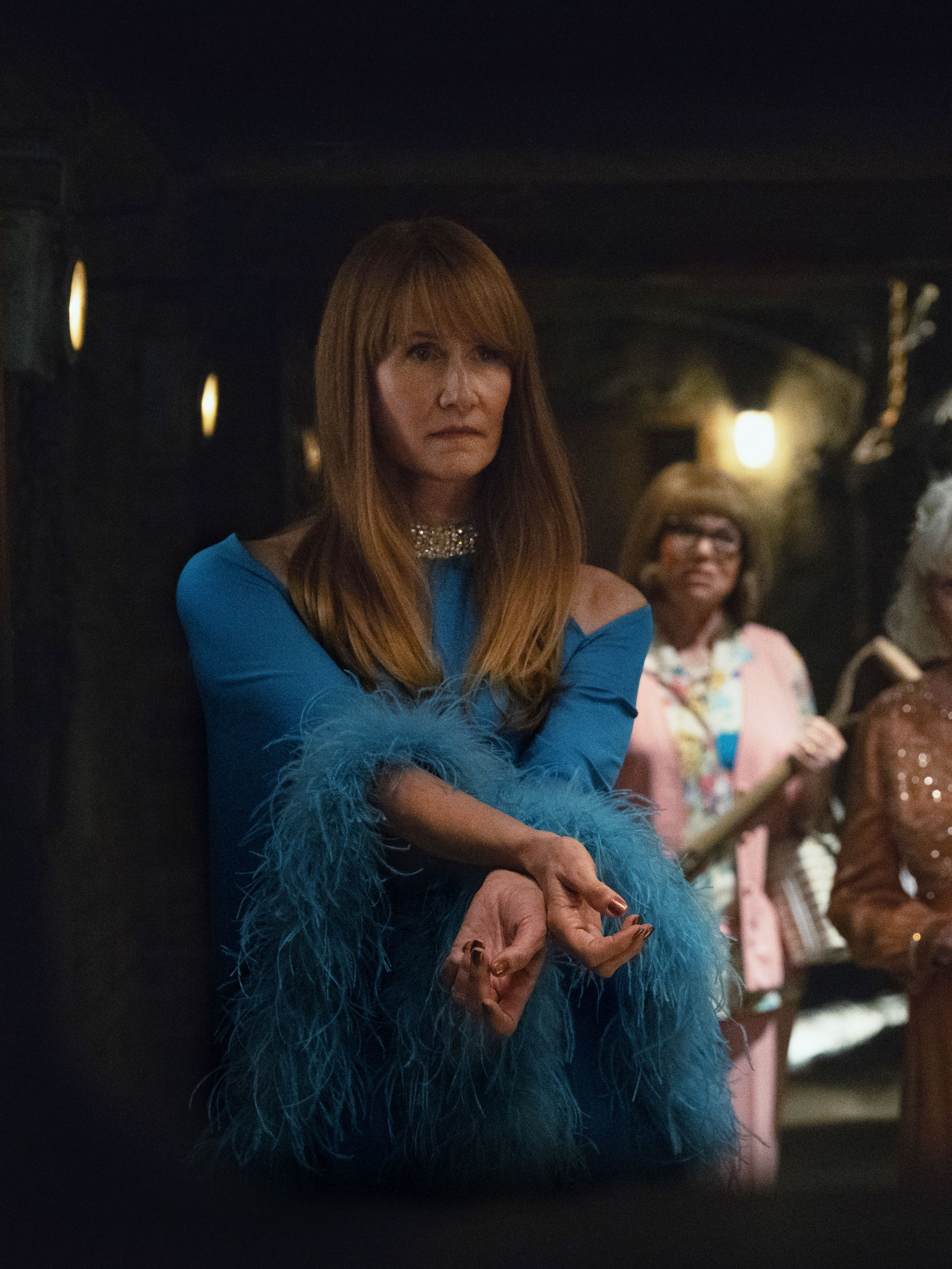 Laura Dern wears a feathery blue dress in Palm Royale fashion