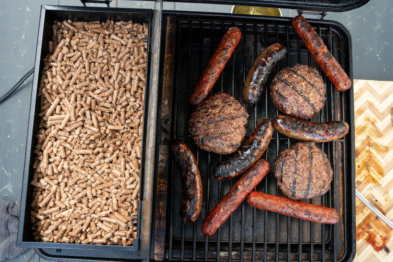 Bratwurst, Grass-Fed Hamburger Patties Cooking In A Portable Smoker, Pellet