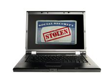 Laptop with a Social Security card and Stolen text in red -- Identity Theft concept