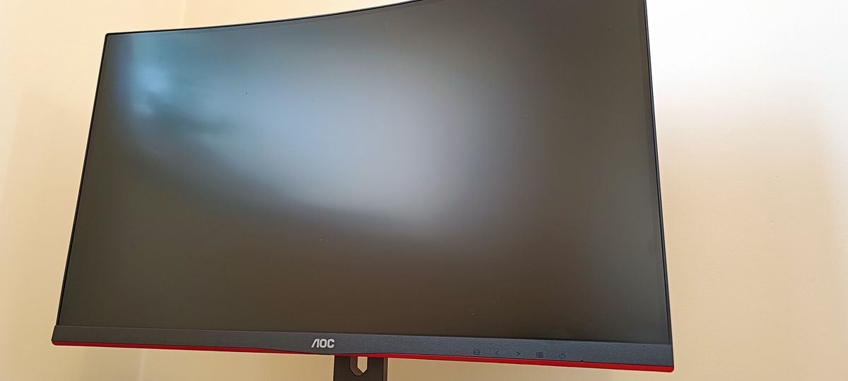 An AOC Gaming C27G2AE curved gaming monitor sitting on a desk