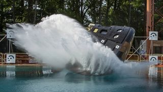 A replica of the Orion moon capsule splashes in a pool during the final water impact test at the NASA Langley Research Center in Hampton, Virginia.