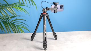 The Joby Compact Tripod against a blue background