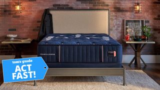 A Stearns & Foster mattress in a brick-walled bedroom with a Tom's Guide 'Act Fast' badge