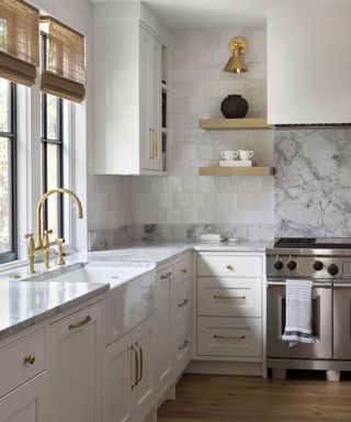 kitchen with white walls and cabinets marble backsplash and wood floors