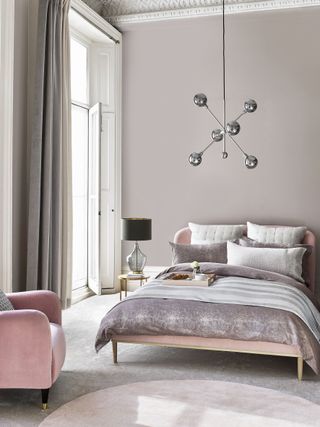 Luxurious pink bedroom with long grey curtains