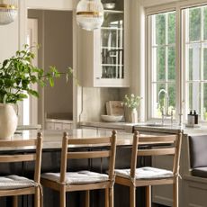 Wooden bar stools at a marble kitchen island