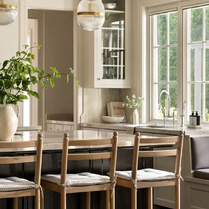 Wooden bar stools at a marble kitchen island